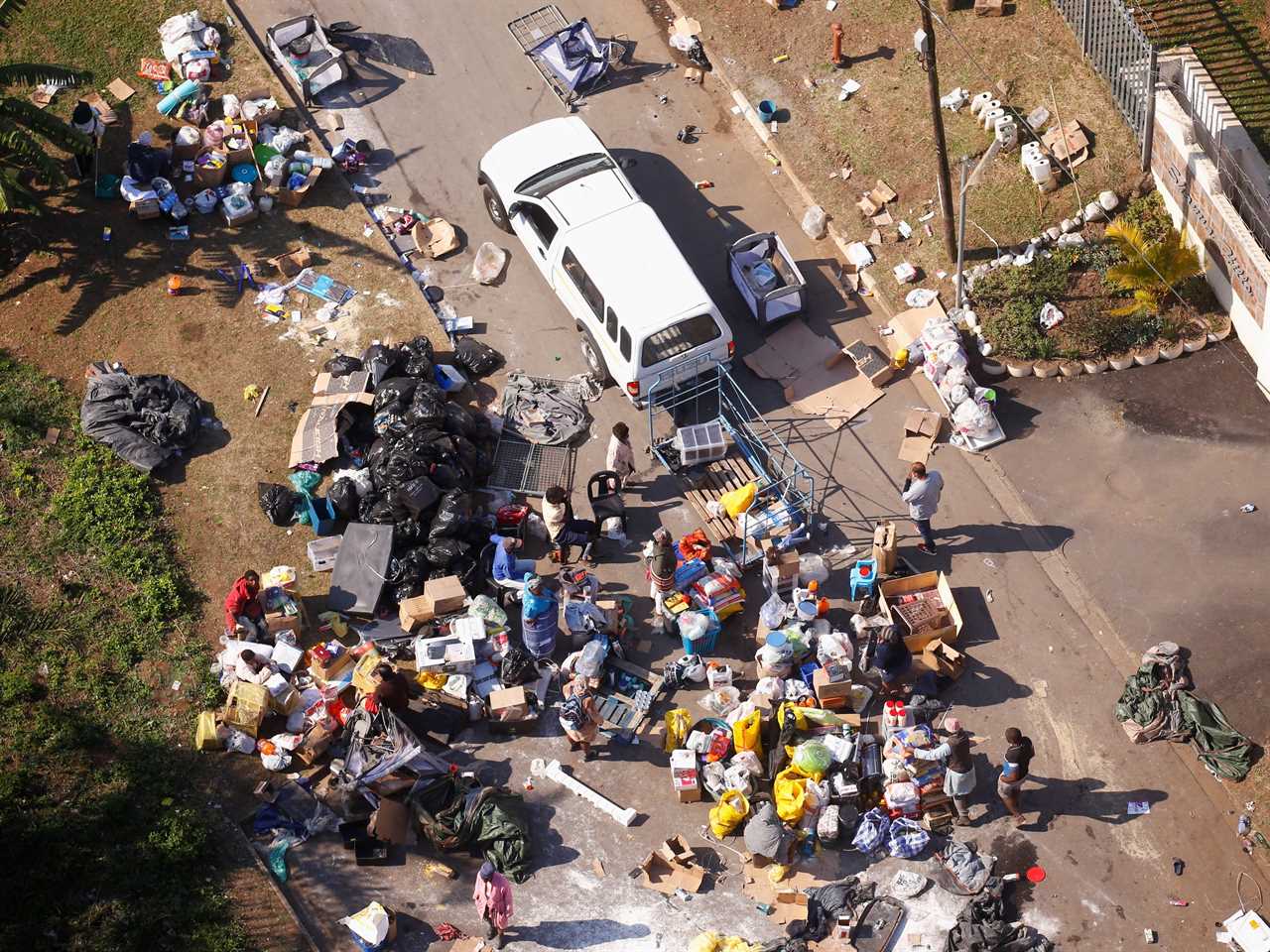 People loot an area near a burning warehouse in Durban, South Africa