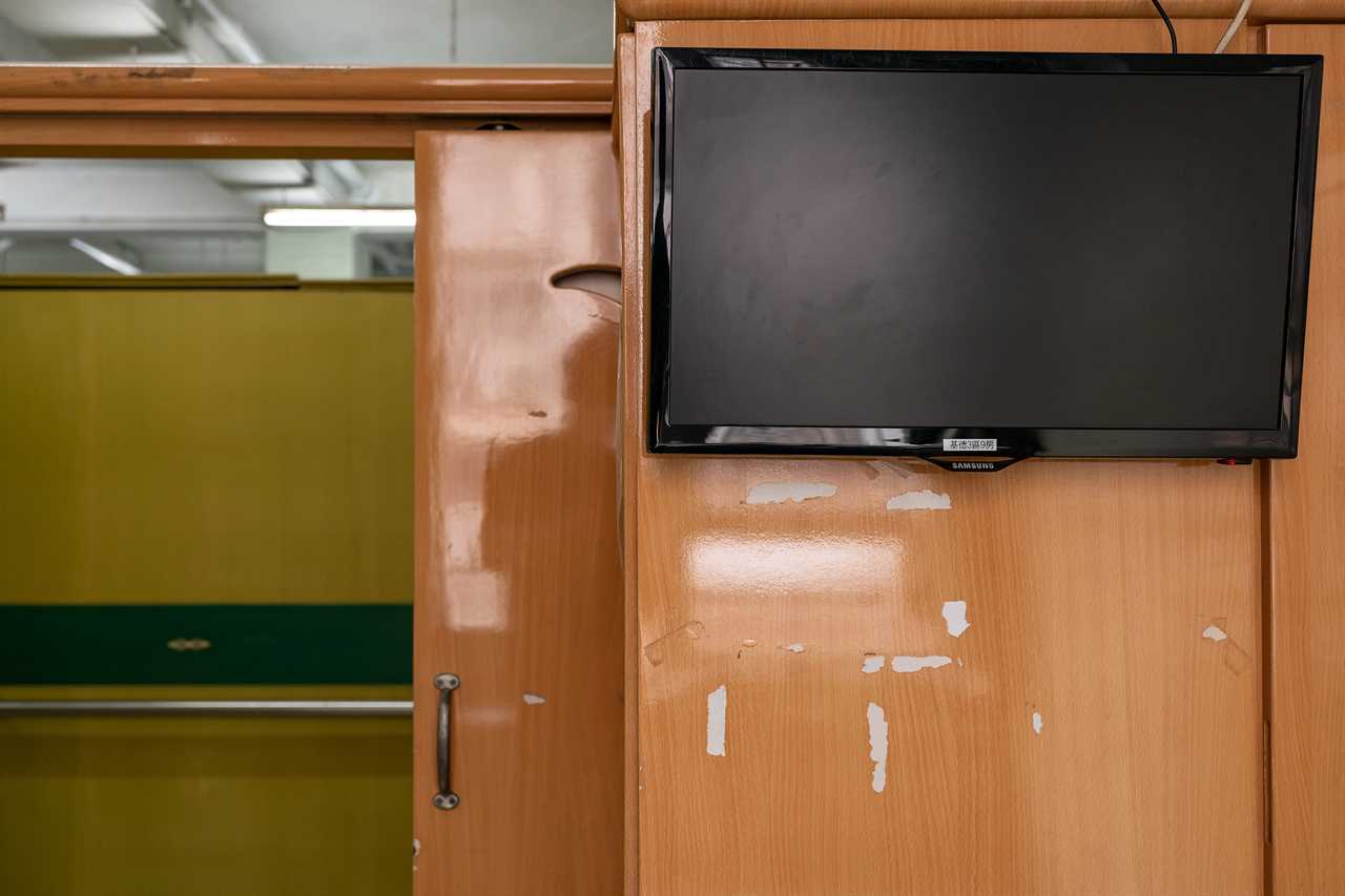 Leftover marks from tape used to hold family photos in the living cubicle of Wong Wing Yanâ€™s godmother who has recently passed away in the fifth wave of pandemic.