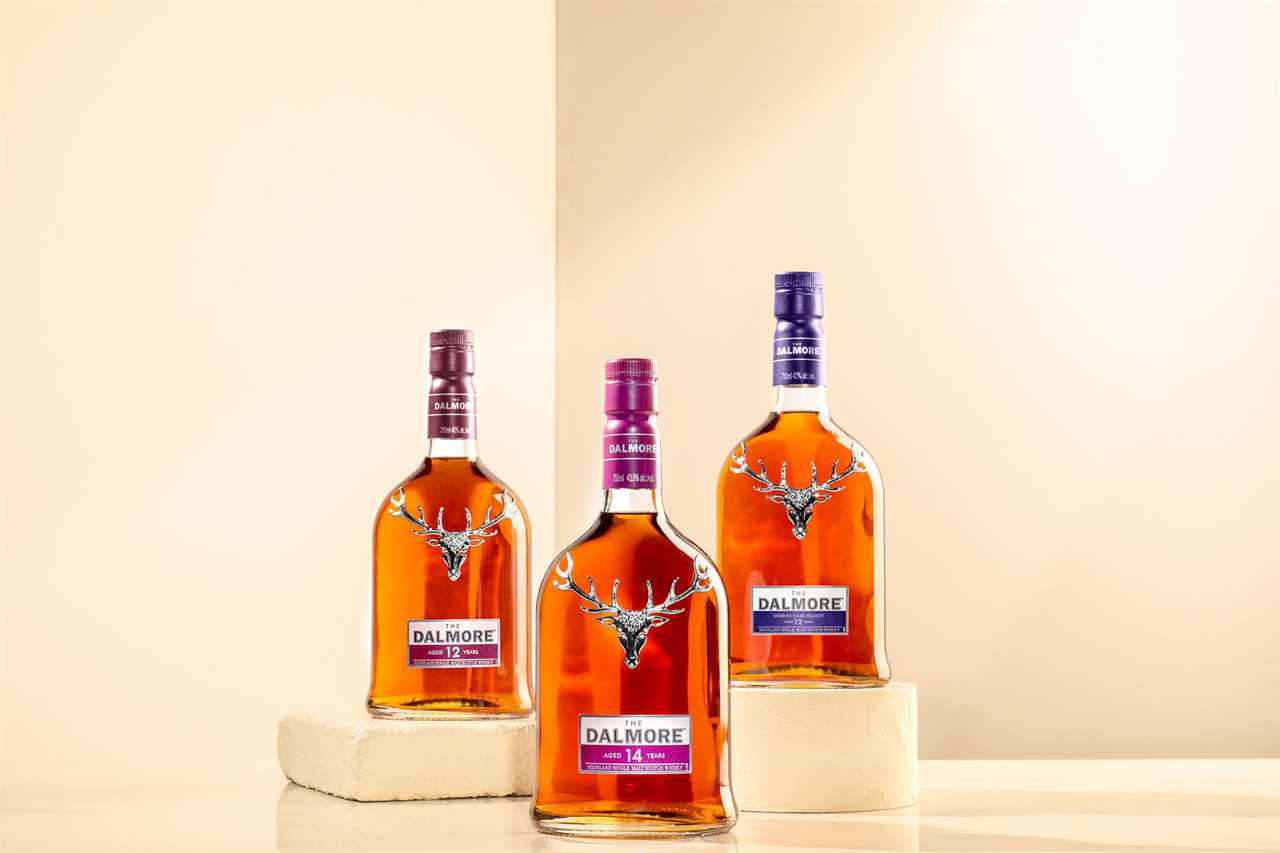 Trio of whiskey bottles with steer on front