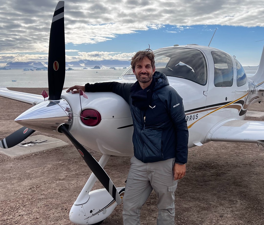 Man standing in front of small plane