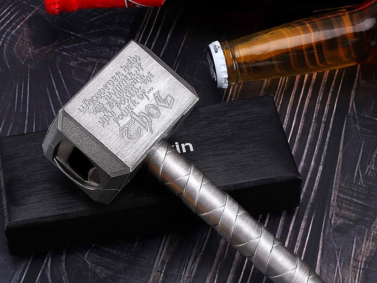 Thor's Hammer bottle opener with a glass bottle by it