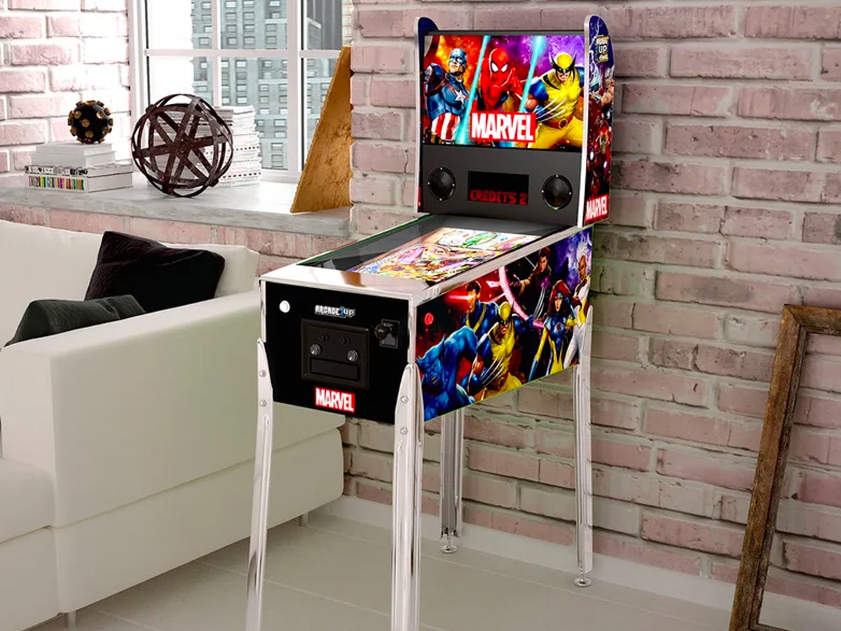 Arcade 1Up Marvel Digital Pinball Machine in a room with a brick wall