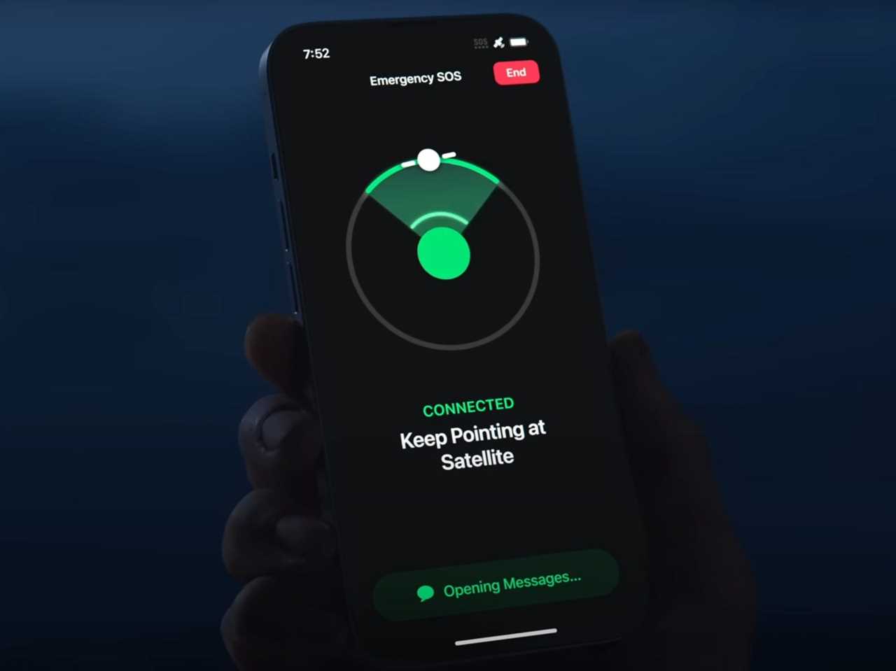 A hand holding a phone that is displaying Apple’s Emergency SOS via Satellite.