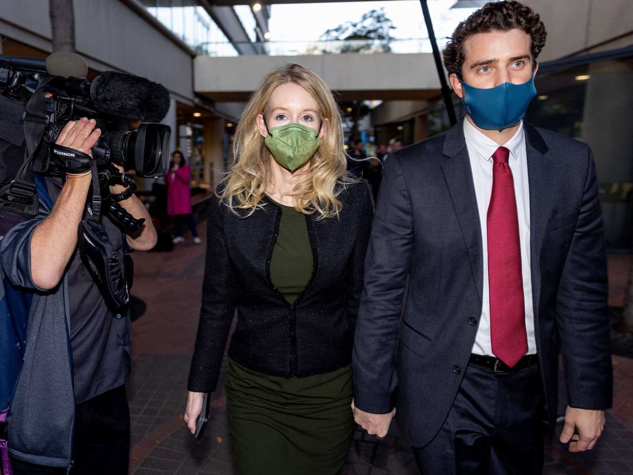 Theranos founder and former CEO Elizabeth Holmes along with her partner Billy Evans (R) leave the Robert F. Peckham Federal Building on November 23, 2021 in San Jose, California. Holmes is facing charges of conspiracy and wire fraud for allegedly engaging in a multimillion-dollar scheme to defraud investors with the Theranos blood testing lab services.