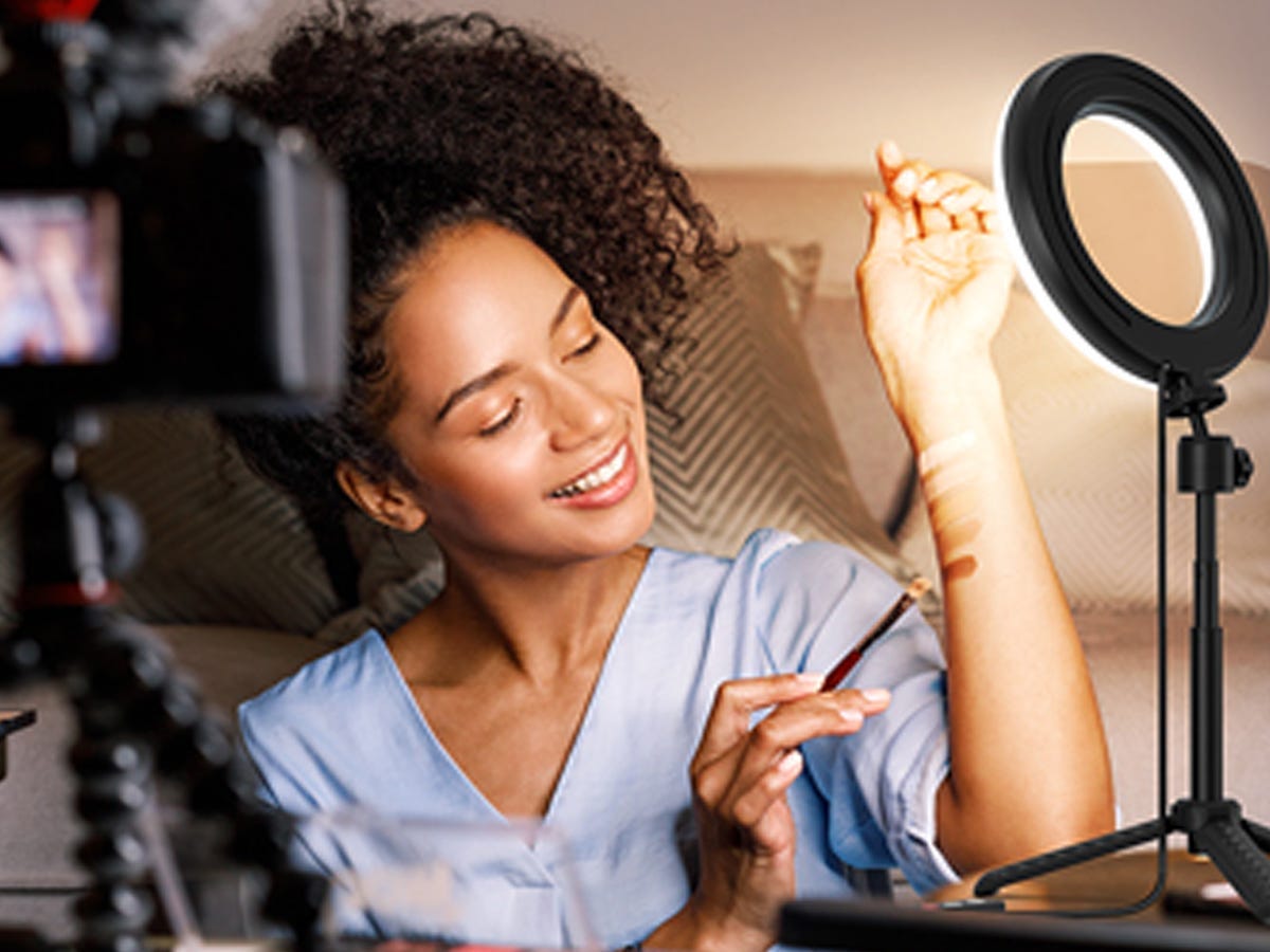 a Webcam Ring Light shines on a person displaying makeup on their arm as one of the best tech products under $50