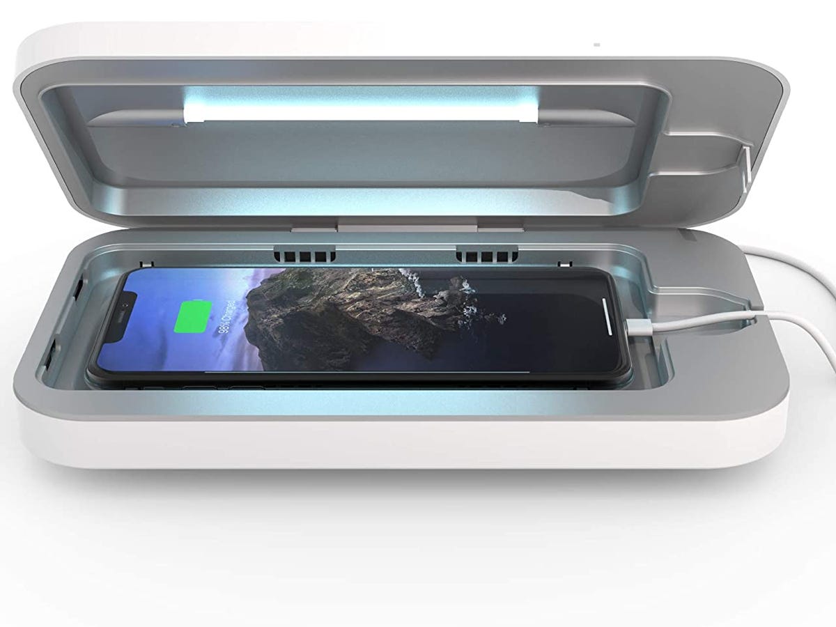 PhoneSoap 3 UV Phone Sanitizer lays open with a phone inside charging as one of the best tech deals under $50