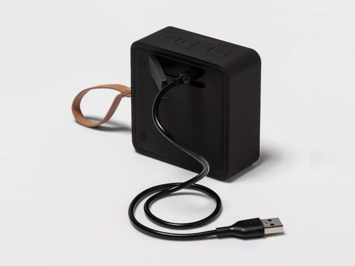 a Heyday Small Portable Bluetooth Speaker with Loop sits on a gray surface with a cord laying adjacent as one of the best tech products under $50