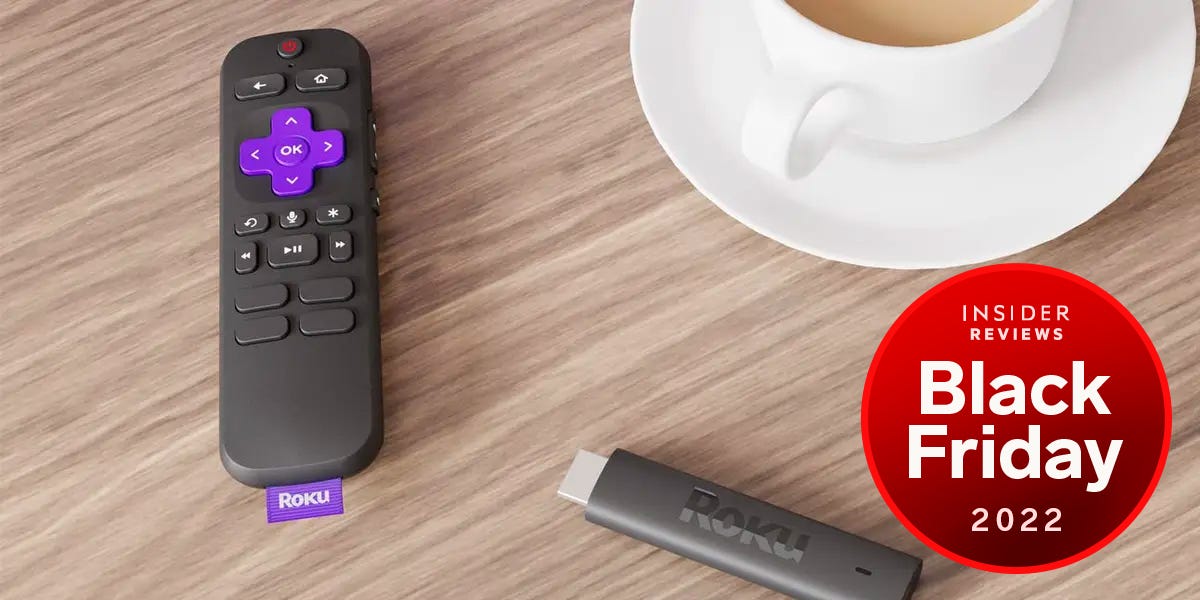 Roku Streaming Stick 4K and remote on a table next to a cup of coffee with a Insider Reviews Black Friday 2022 badge in the bottom right corner.