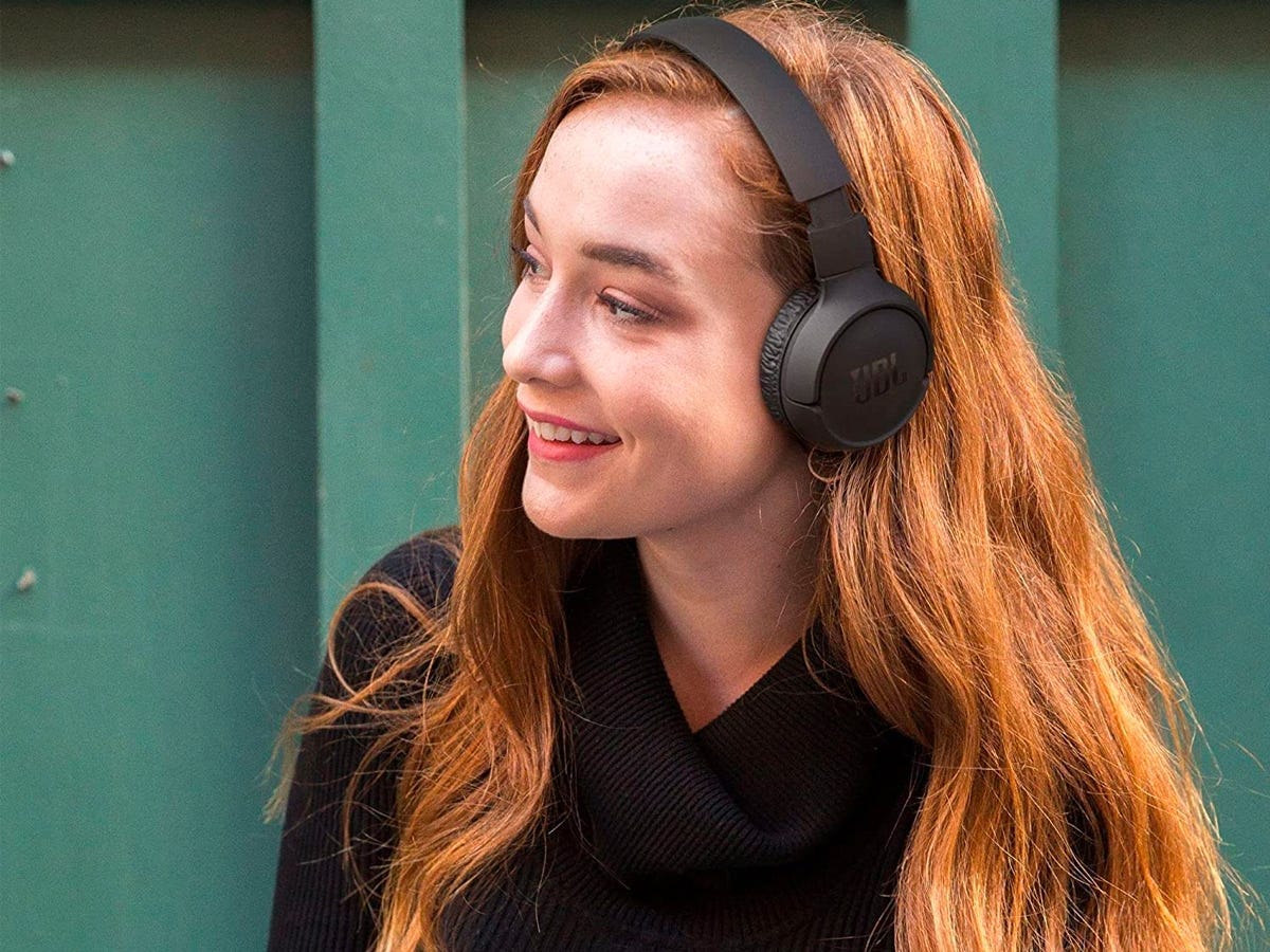 Person wearing the JBL Tune 510BT headphones and smiling, one of the clever gift ideas on sale for Black Friday