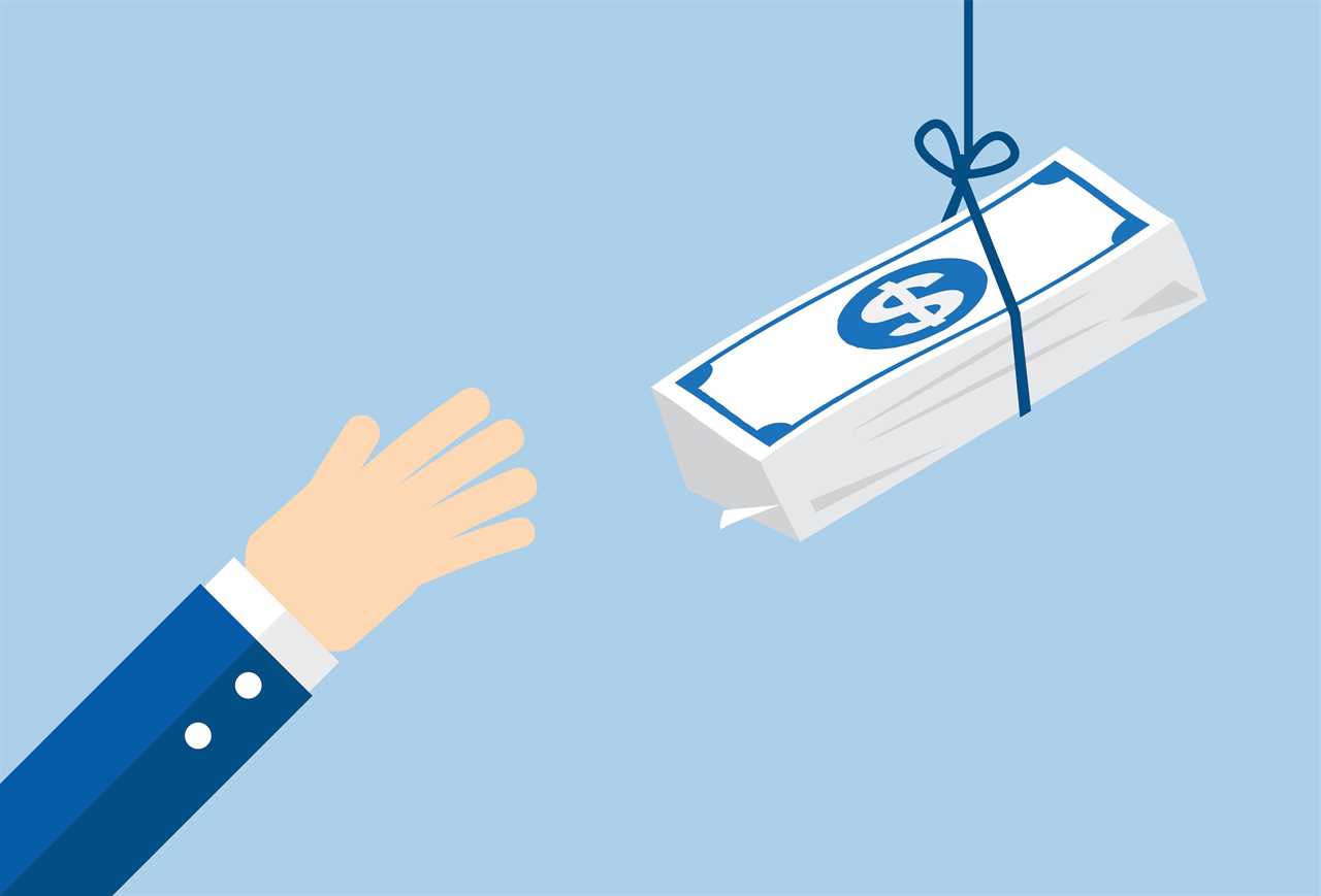 a hand reaches out to grab money hanging from a string