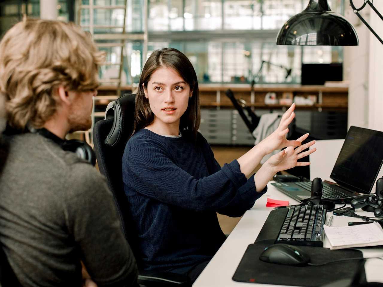 Co-workers talking and sitting in an office