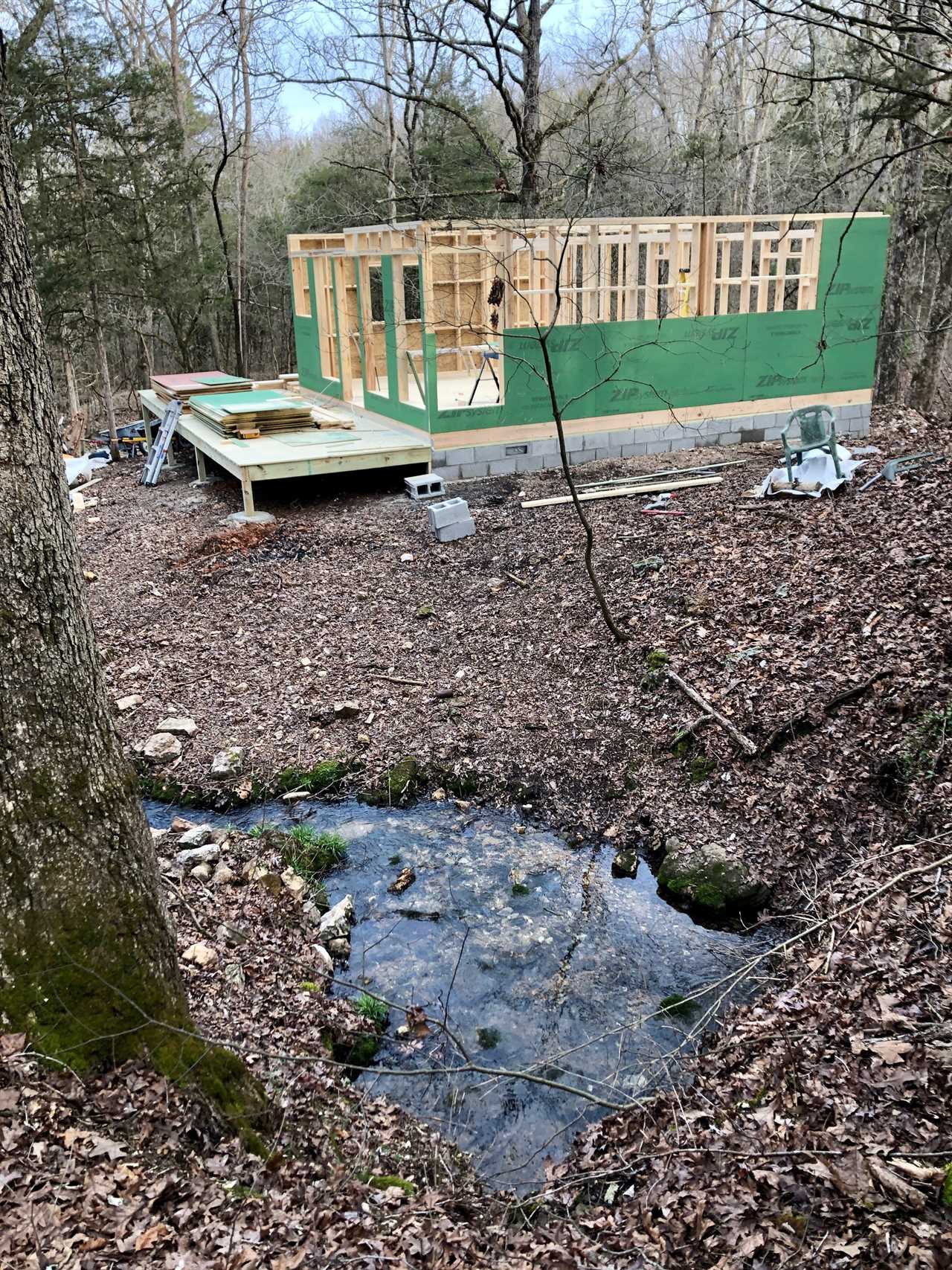 A house being build next to a small spring