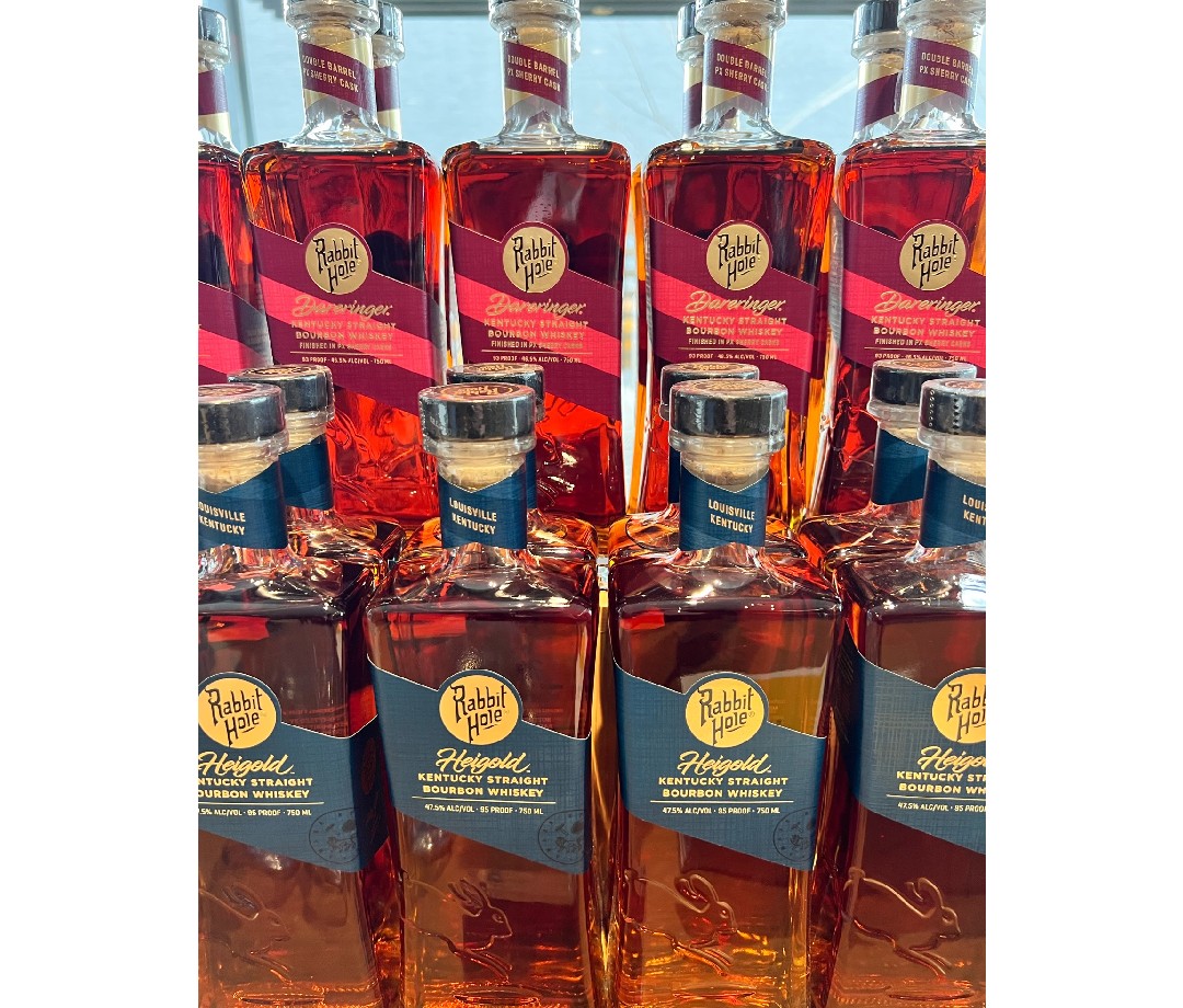 Two rows of Rabbit Hole whiskey bottles.