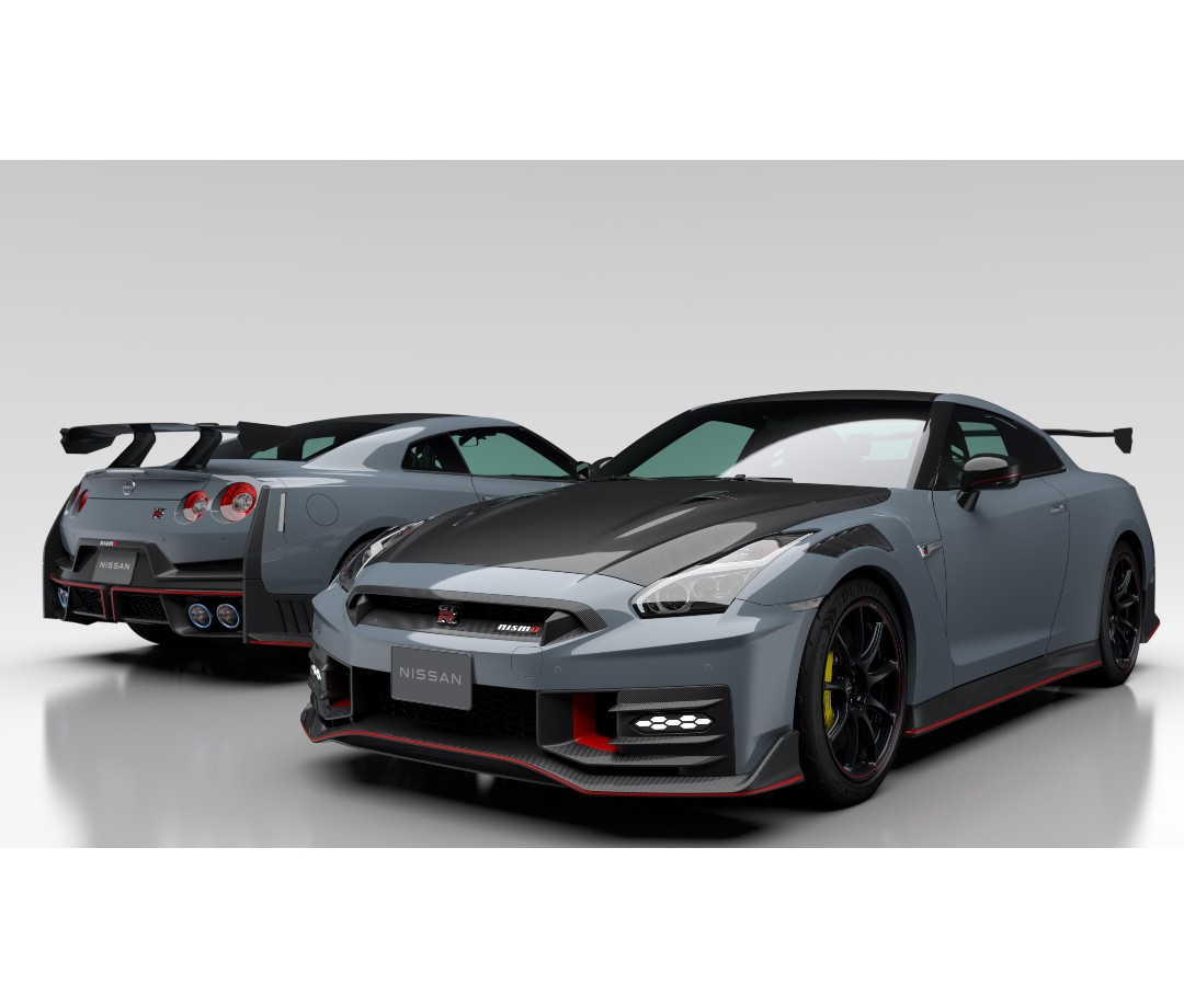 Two silver sports cars in showroom facing different directions