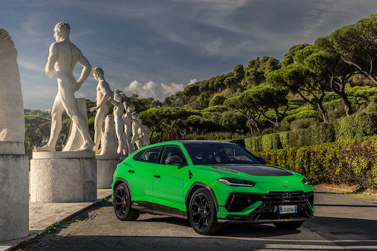 Bright green sports SUV in front of white sculptures