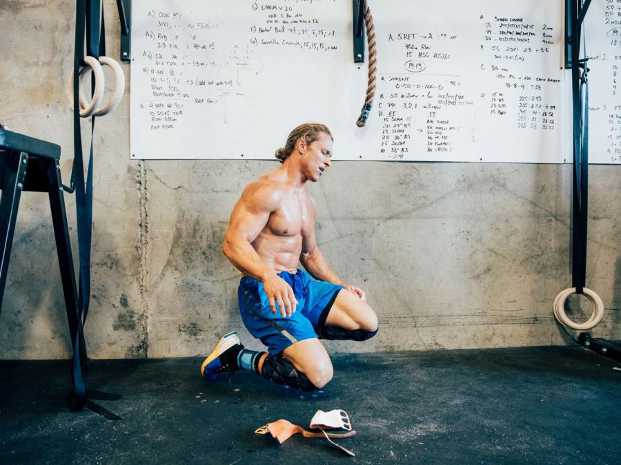 Fit man resting in CrossFit gym