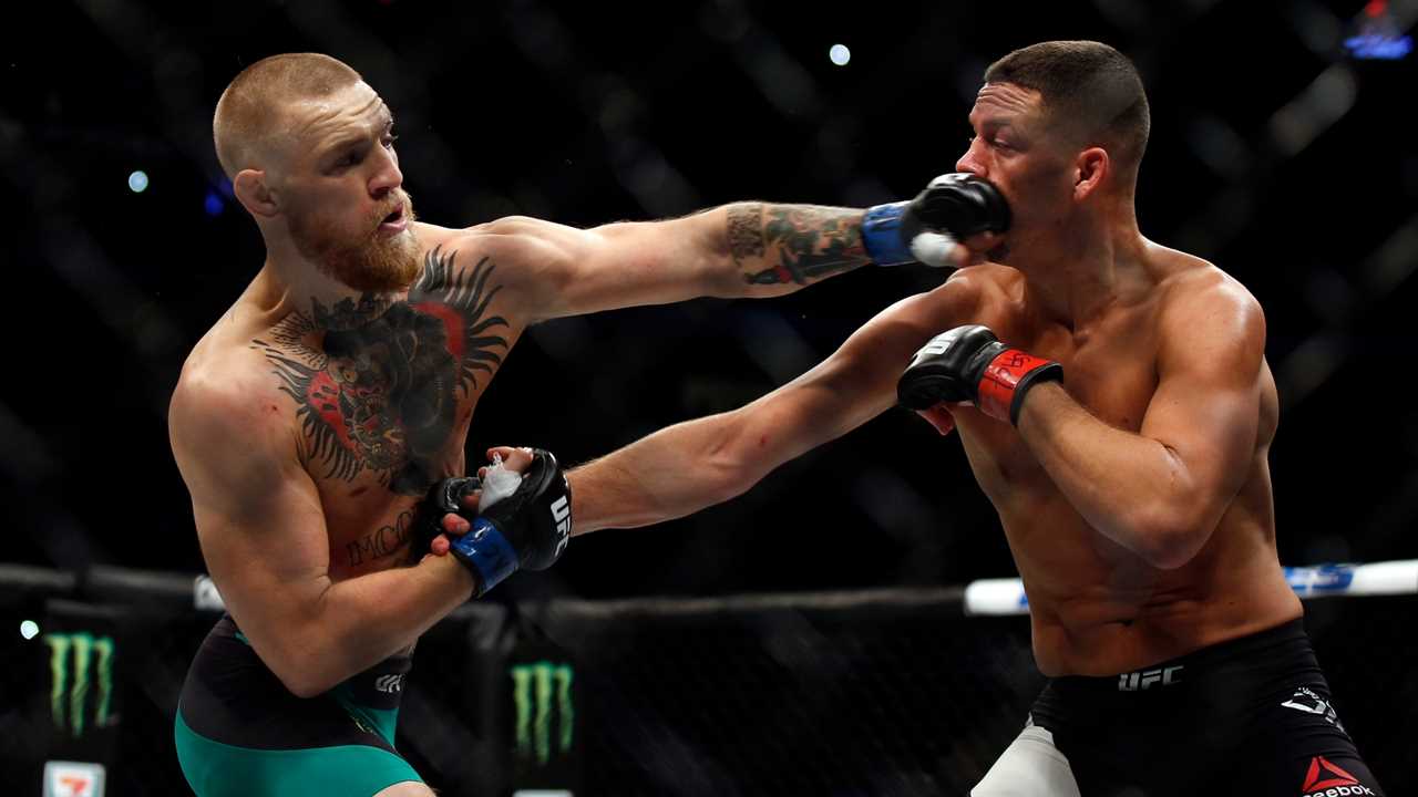 Greatest UFC fights of all time. Conor McGregor punches Nate Diaz during a match in 2016