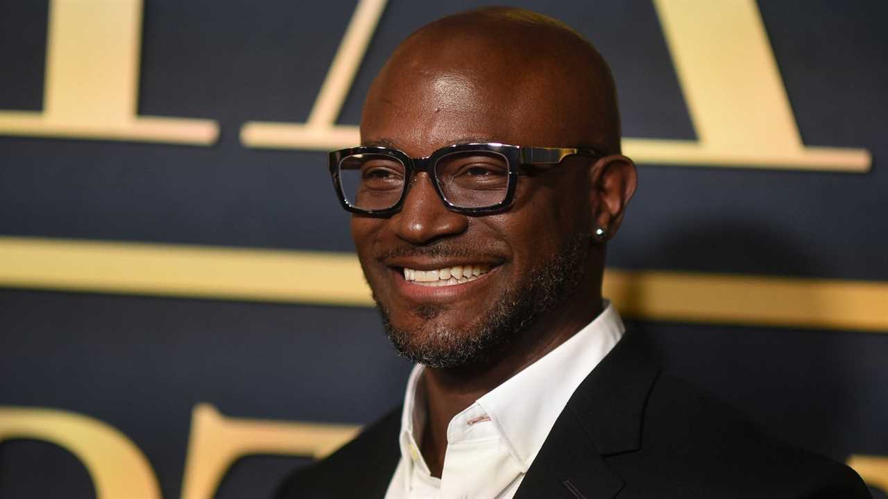 Black man wearing thick-frame glasses on red carpet