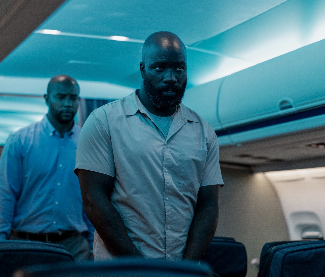 Actor Mike Colter on a plane during a scene from the movie 'Plane'.