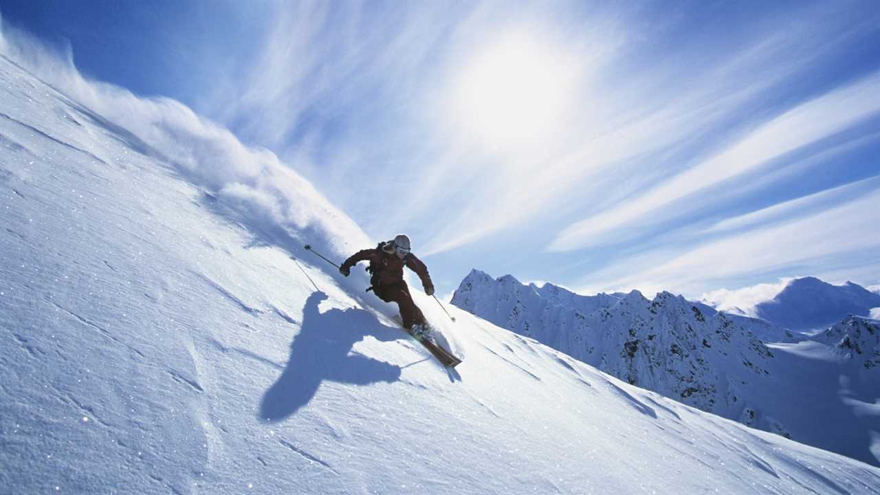 Man skiing down a slope. ski boots