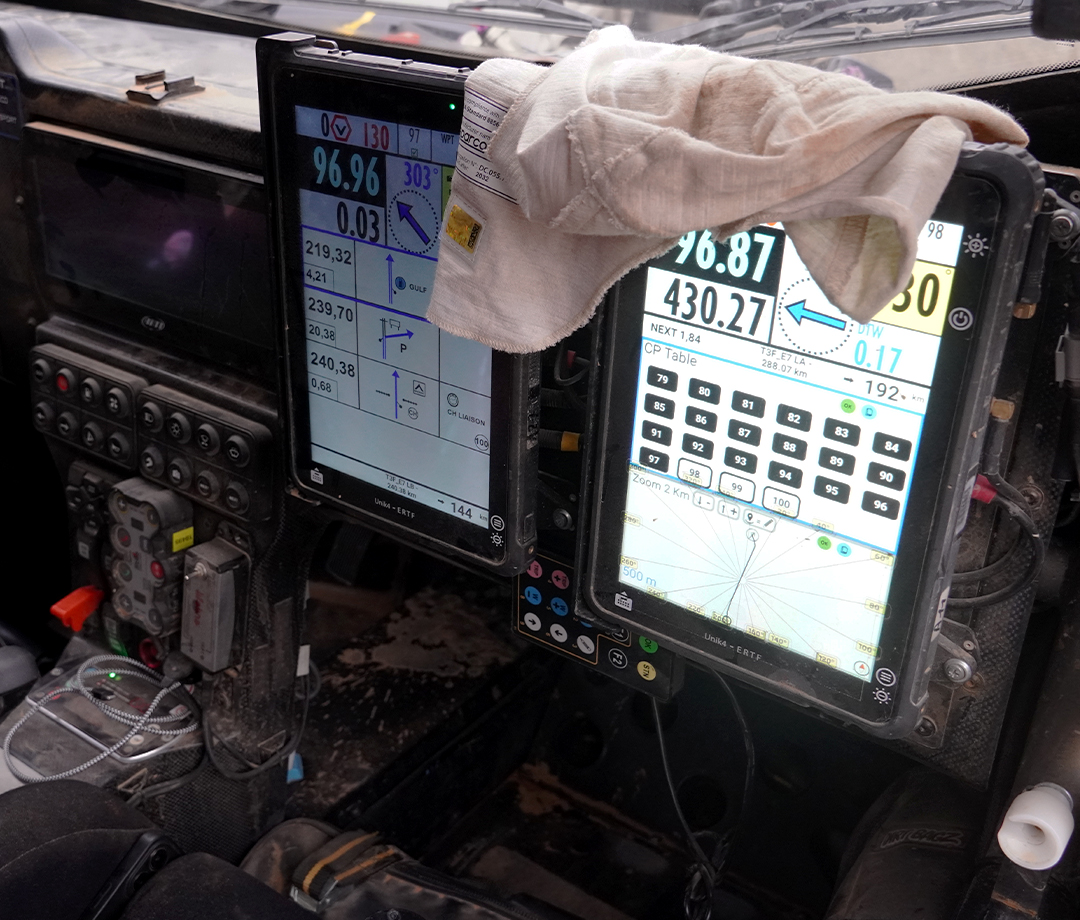 Digital dashboard displaying times and routes in a Dakar side by side off-roader.