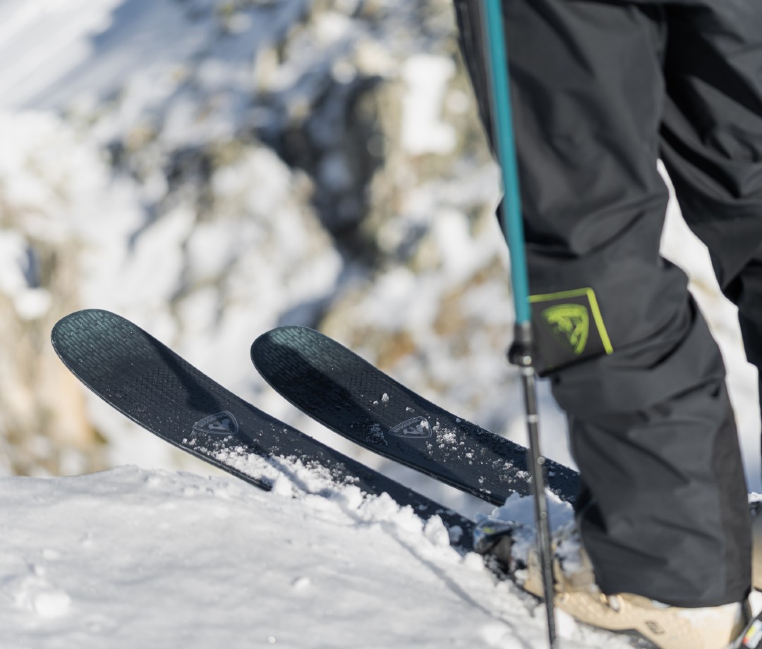 Skier on precipice of mountain edge