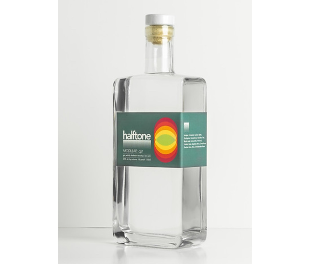 Rectangular, clear bottle of gin with a green label on an off-white background.