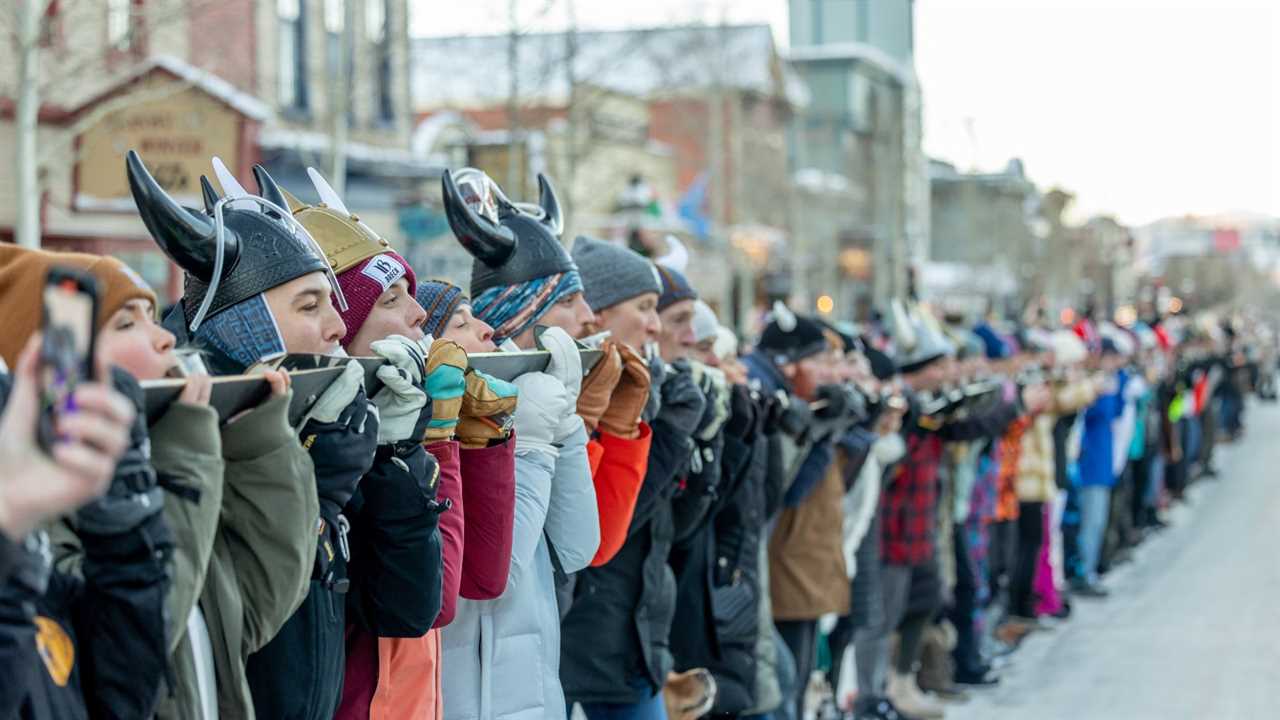 Long line of people doing shot ski