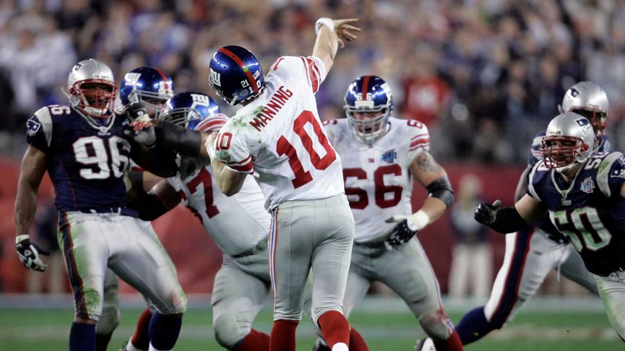 Eli Manning finishes a throw. best super bowl games.