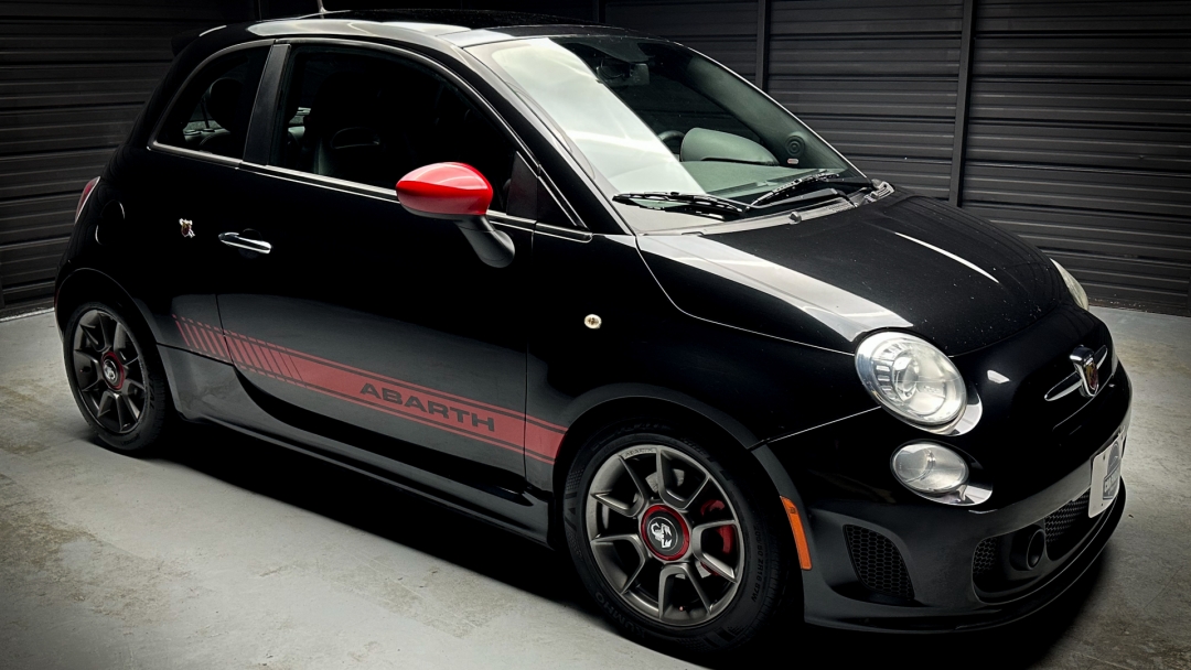 Black 2013 Fiat 500 Abarth in a showroom. car auctions