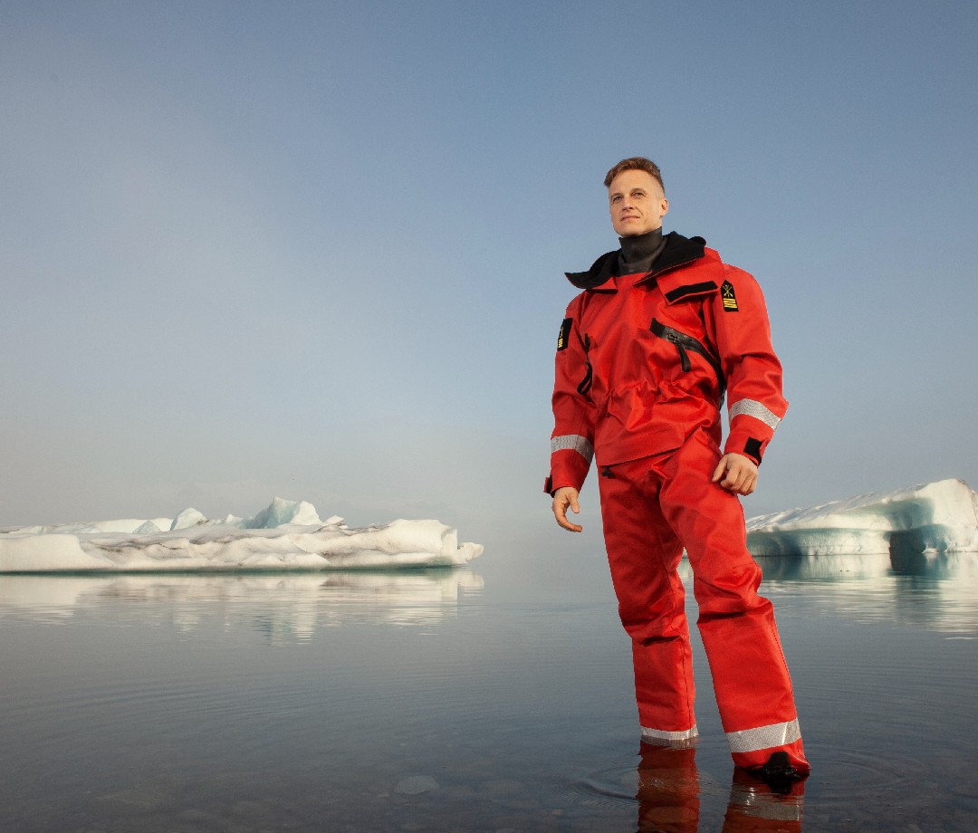 Fiann Paul standing by an ice flow.