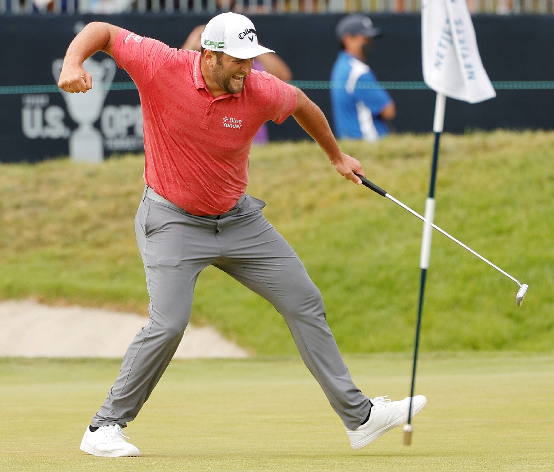 Jon Rahm celebrating on the course after a shot. 