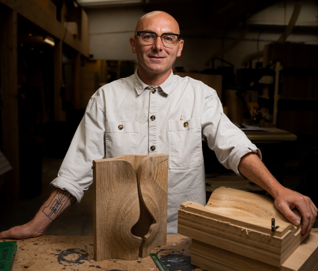 Award-winning designer John Galvin poses in front of bespoke box meant to mimic Orkney’s famed cliffs of Yesnaby.