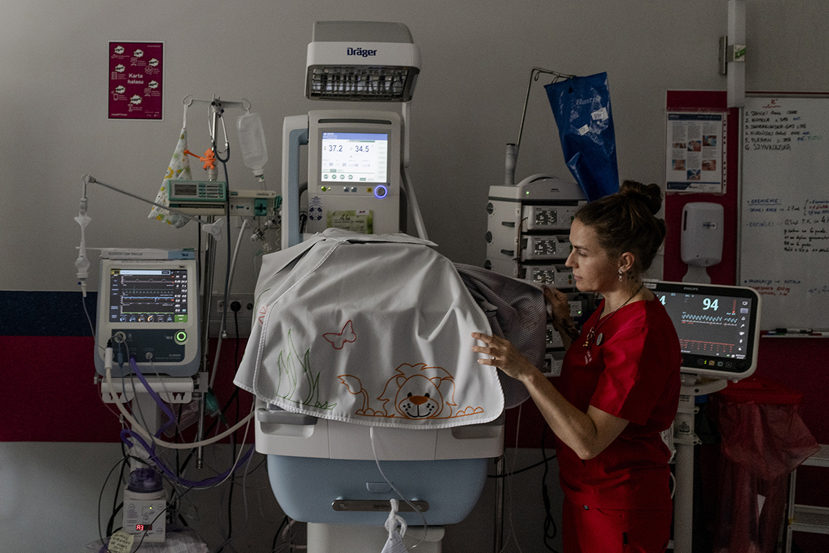 Dr. Gizela Jagielska, a gynecologist and the deputy director of the public hospital in Olesnica, Poland, looks into the incubator of a newborn, on July 28, 2023. The baby was born following a likely failed self-induced abortion, according to Dr. Jagielska. He was delivered at 21 weeks and abandoned at the hospital. He died within days.