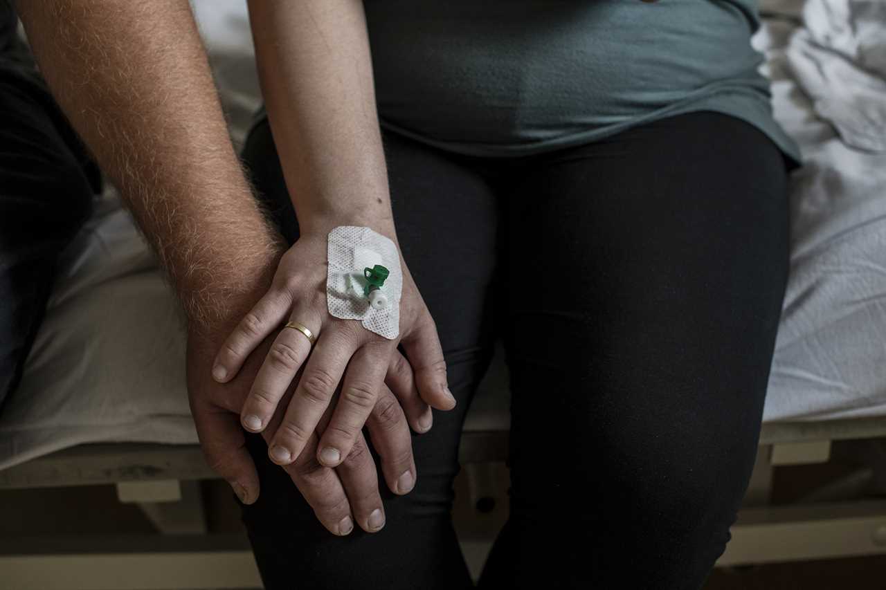 Joanna and Marek sit in a hospital room in Olesnica hospital on Aug. 1 while waiting for the abortion procedure to begin.