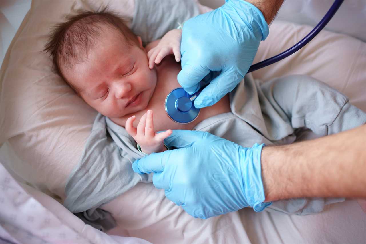 Doctor uses stethoscope to listen to baby