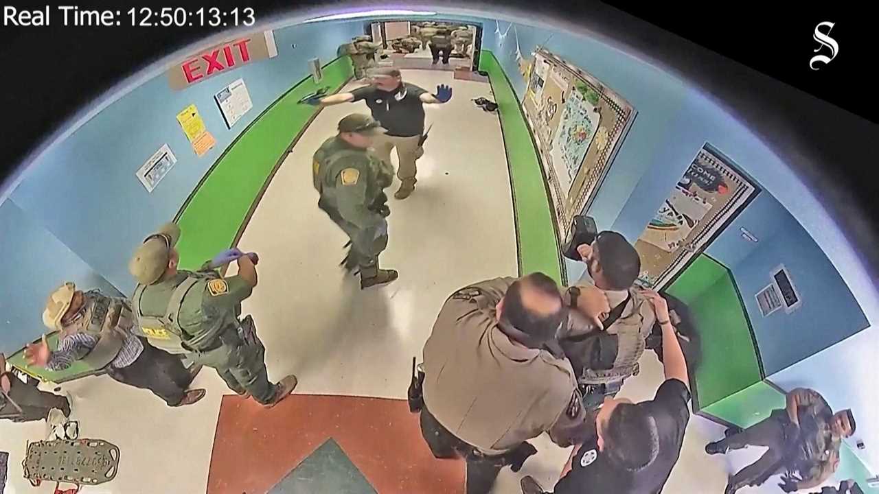 Surveillance footage showing police scattered throughout an elementary school hallway