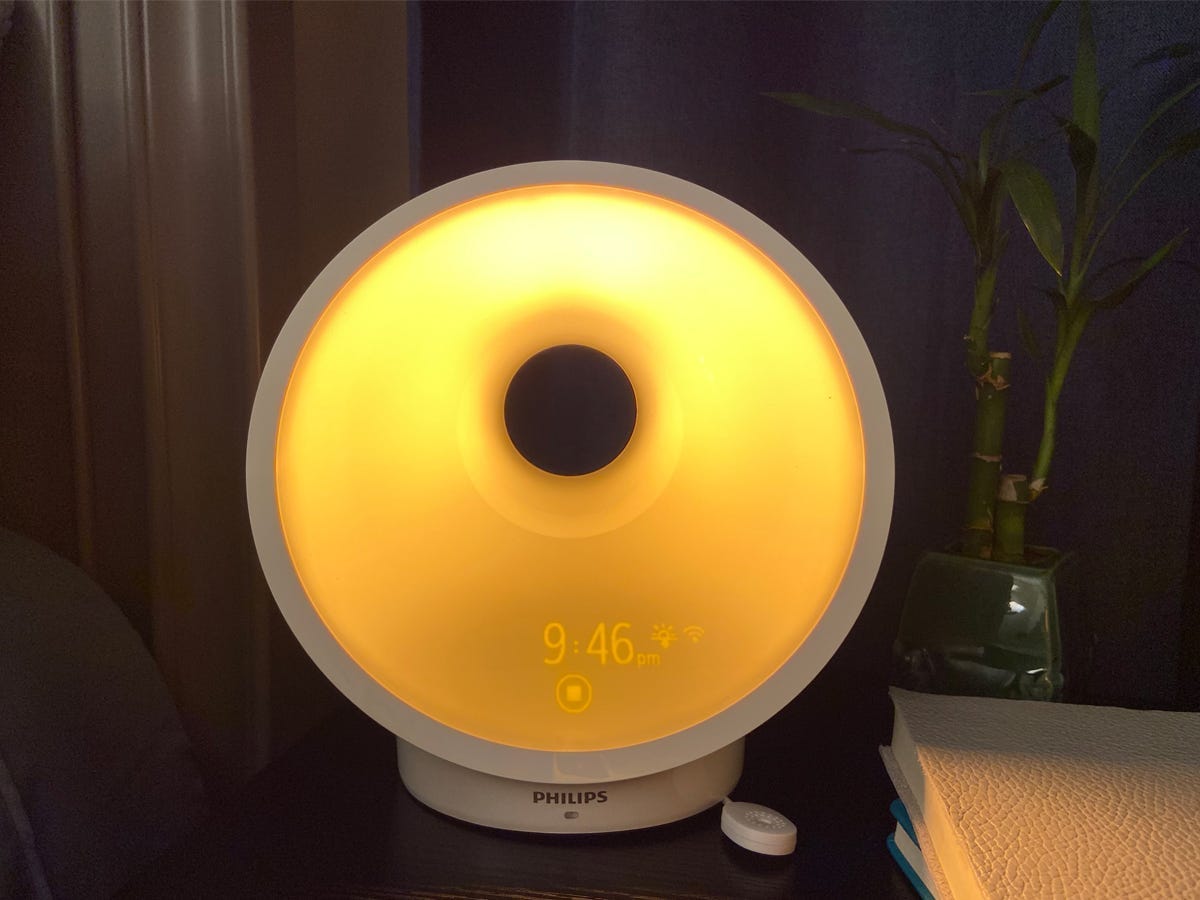 Philips Smartsleep Connected sunrise alarm clock on a bedside table.