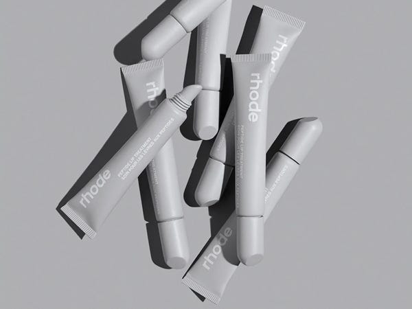 A pile of tubes of Rhode Peptide Lip Treatment.