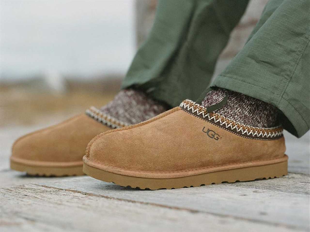 Person's feet wearing UGG Tasman slippers.