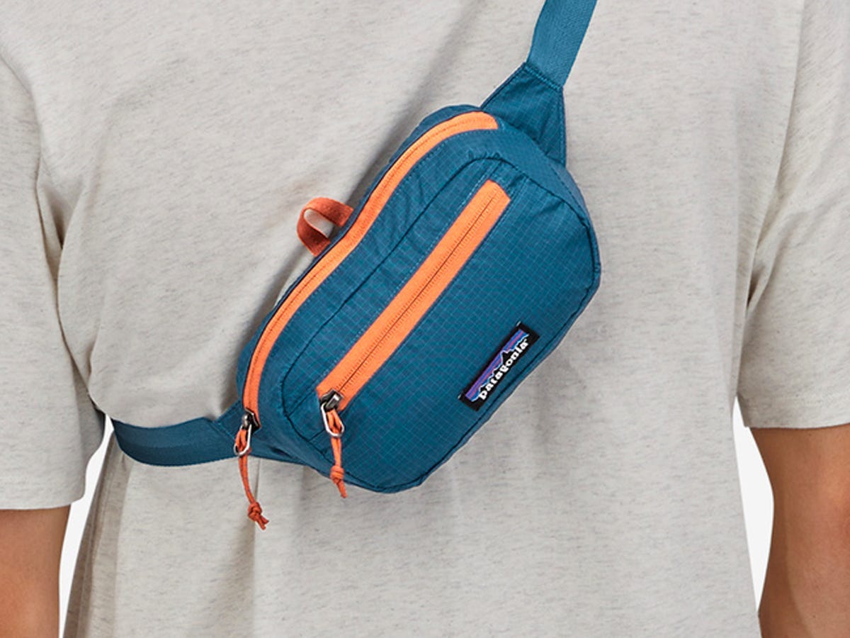 Person wearing the Patagonia Ultralight Black Hole Mini Hip Pack across their back.