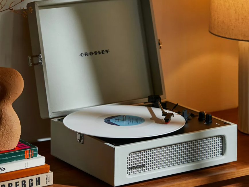 Crosley Voyager Bluetooth Record Player open on a dresser.