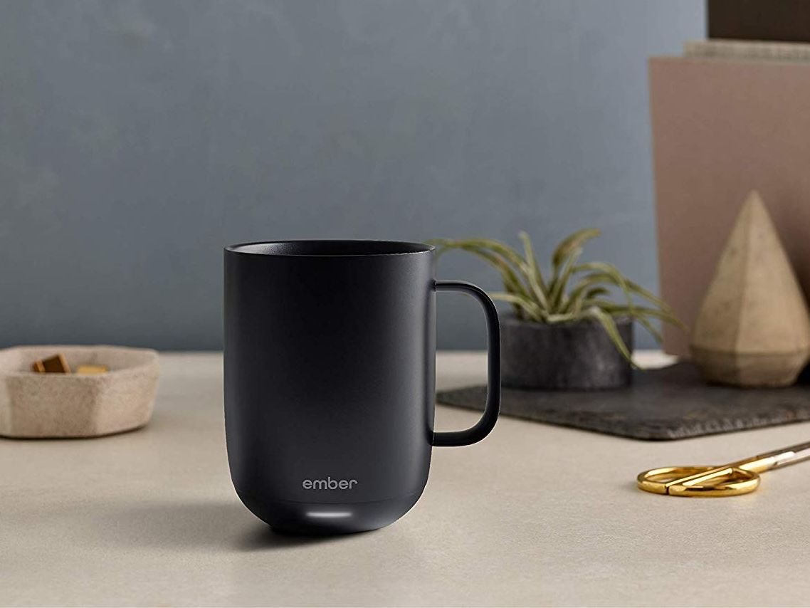 The black Ember Mug on a table.