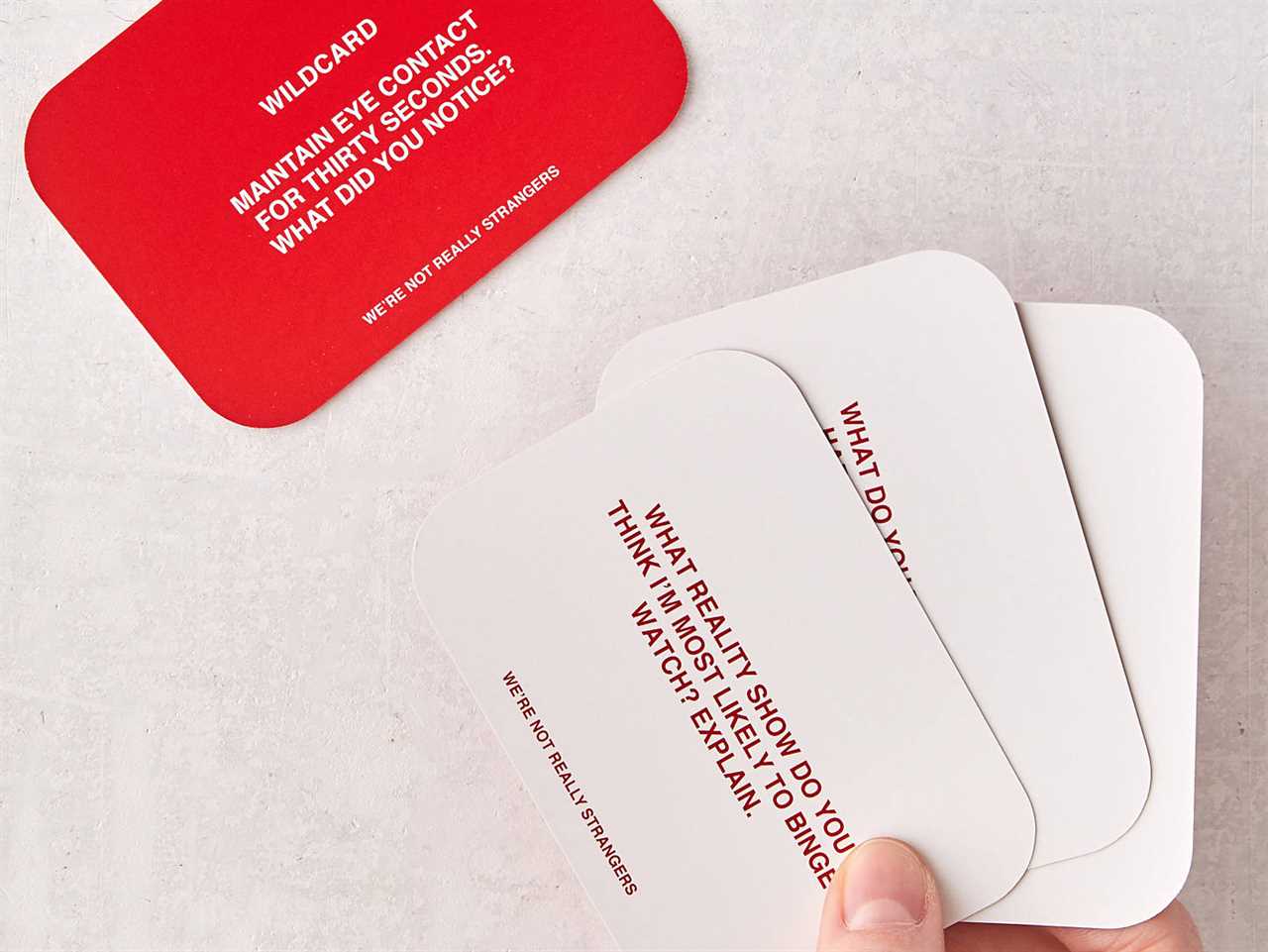 Cards with questions on them from the We're Not Really Strangers Card Game.