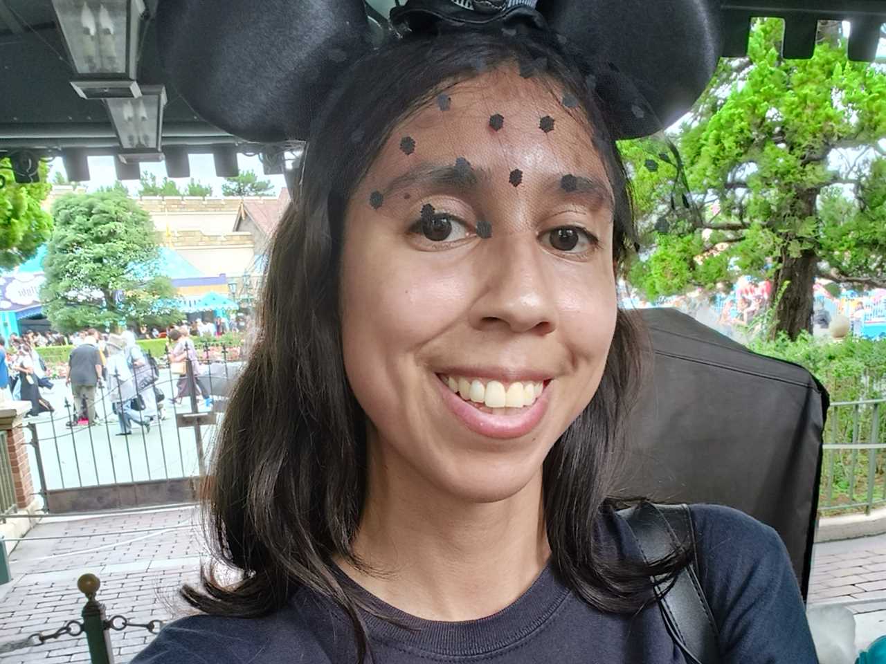 Woman with Micky Mouse ears at Disneyland in Hong Kong