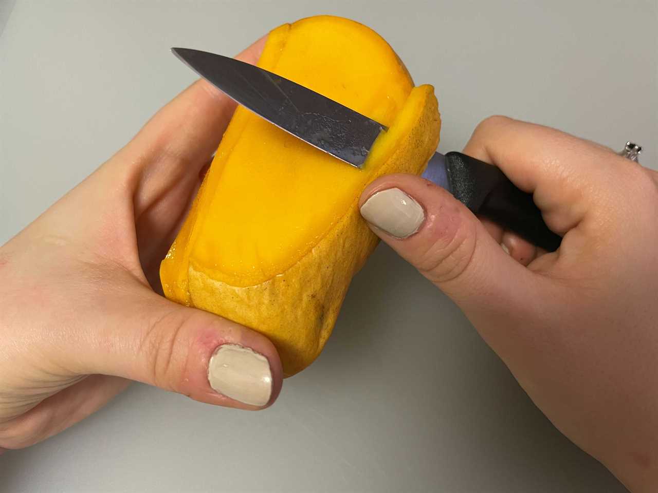 Victorinox Swiss Classic Paring Knife cutting a mango.
