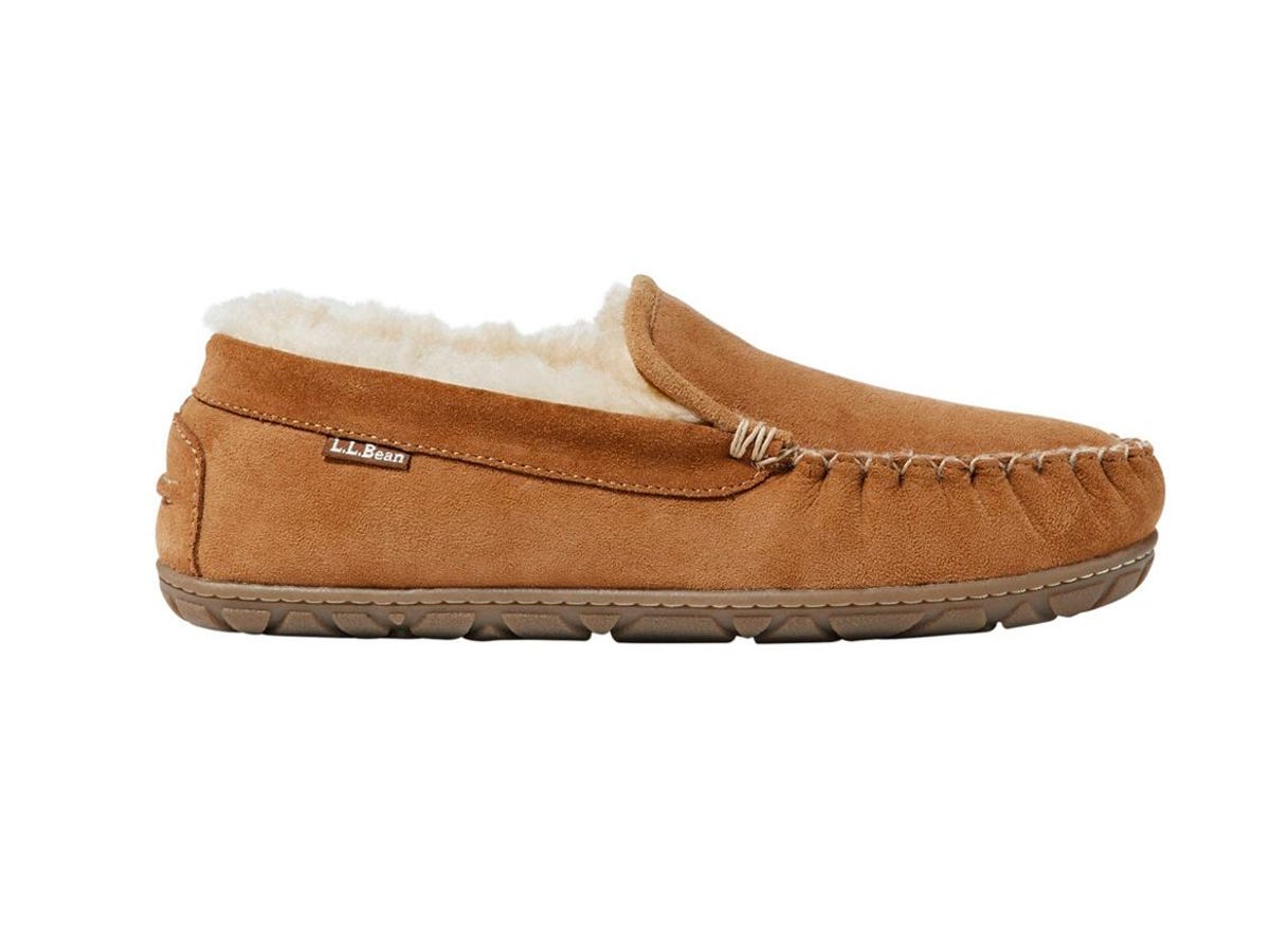 A moccasin style slipper with fur inside.