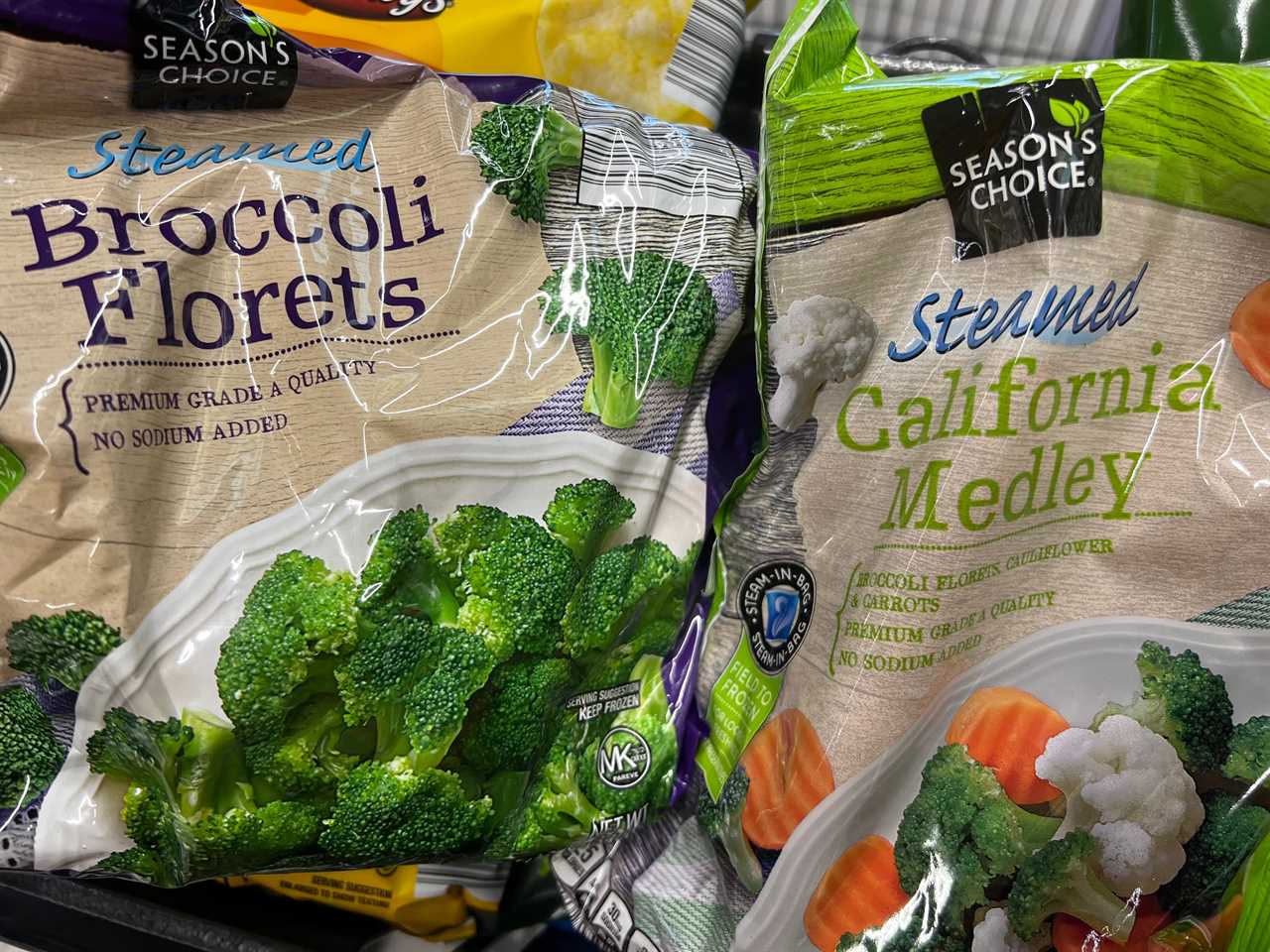 A bag of Season's Choice steamed broccoli florets and a bag of Season's Choice steamed California medley.