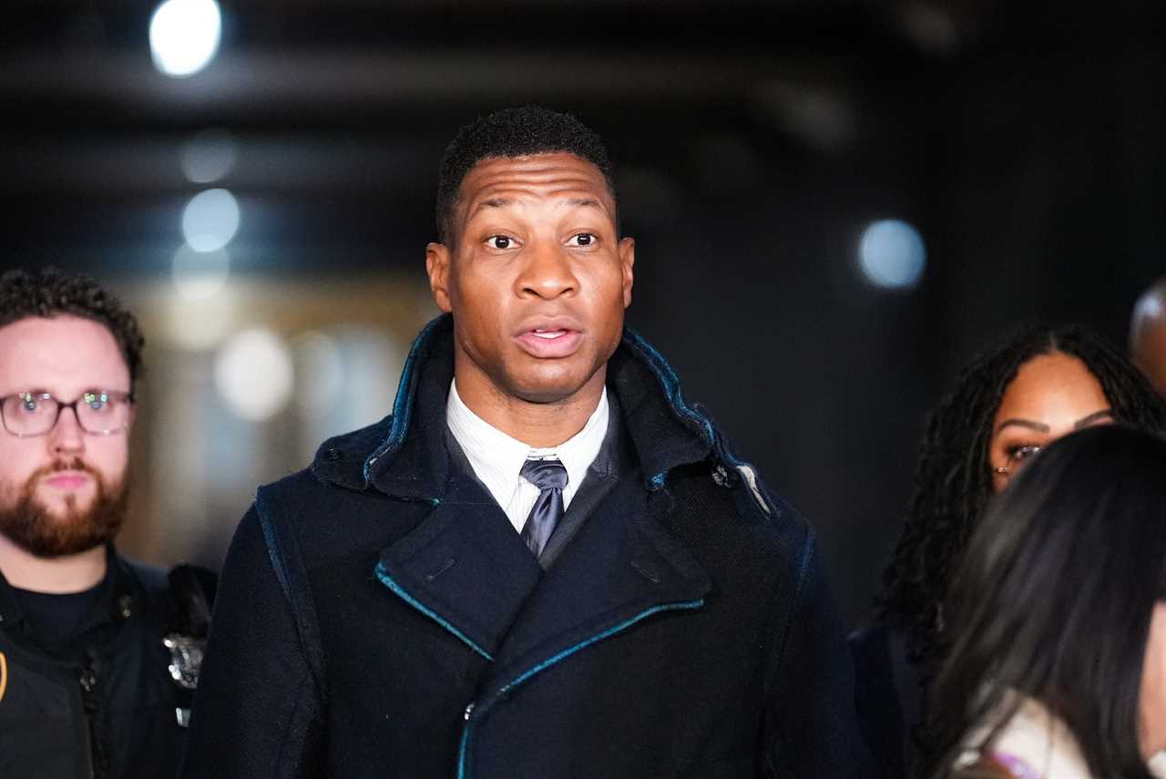 Jonathan Majors in a dark jacket