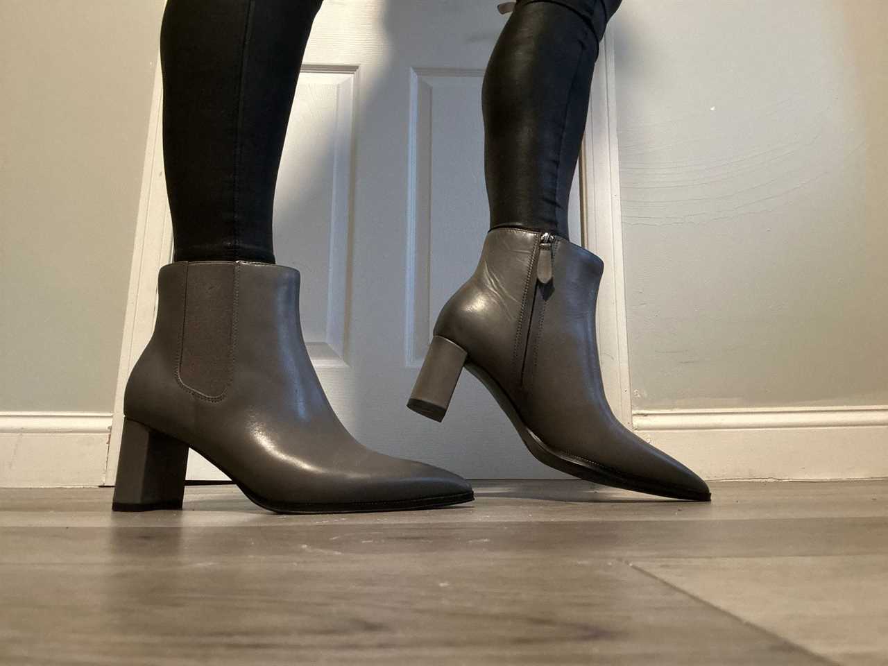 Person wearing a gray pair of Franco Sarto Demmi Booties with leggings.
